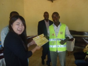 Minister for roads Makueni  County &  CORE CEO Yuka Iwamura giving out certificates to youths at makueni county